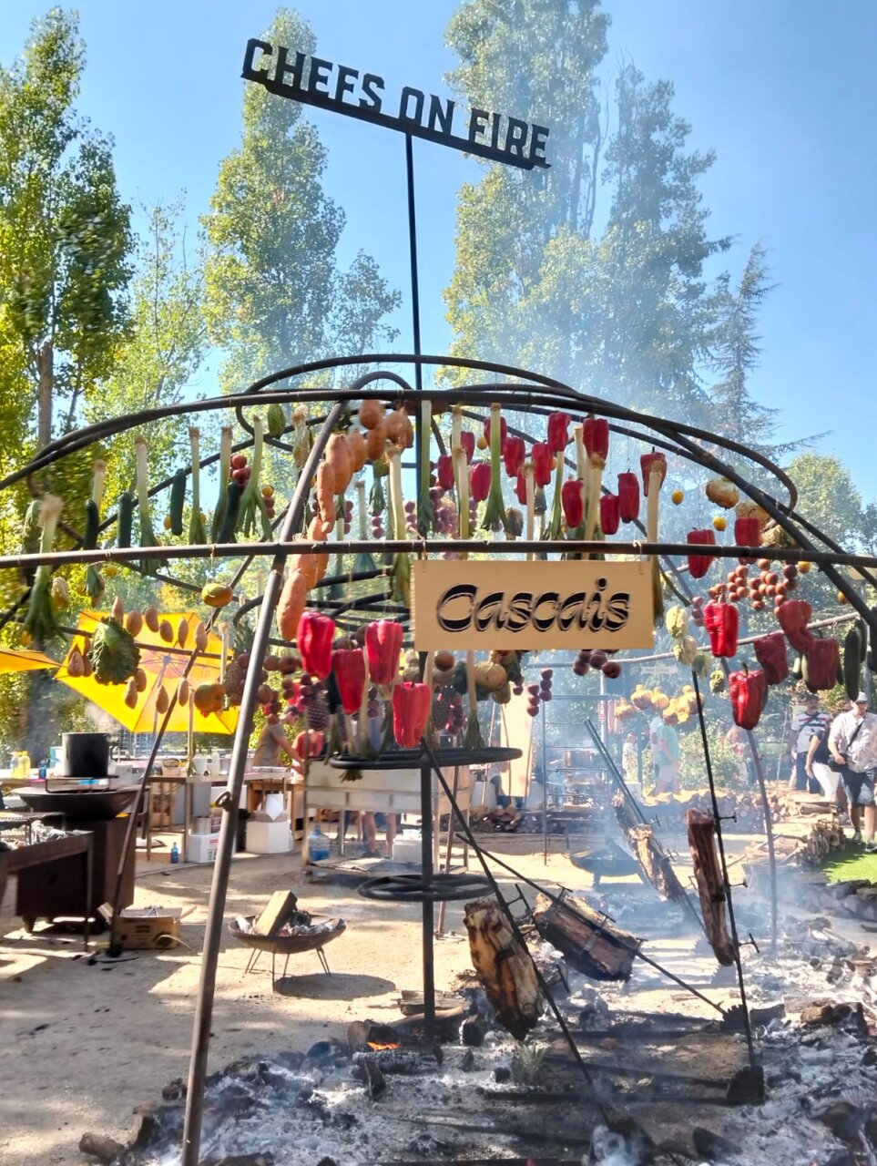 Escena del evento Chefs on Fire con parrillas y vegetales asados.