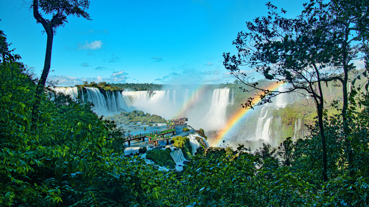 Vista panorámica de las Cataratas del Iguazú con arcoíris y vegetación